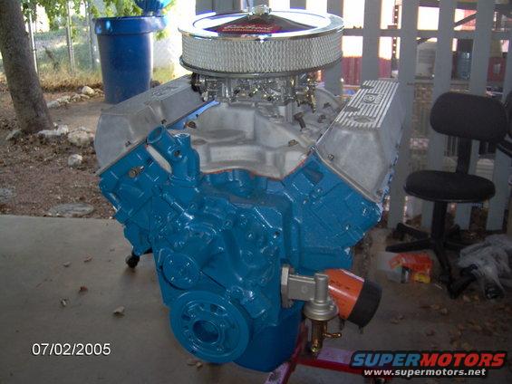 blue V8 engine with chrome air cleaner and fuel pump