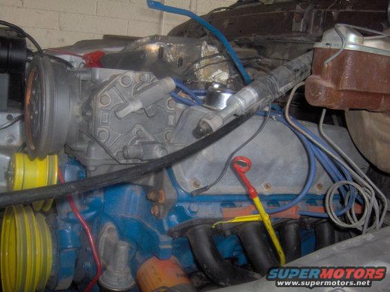 Engine bay with air conditioning compressor and blue engine block