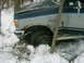 1990 Ford Bronco - This 1990 Ford Bronco is stuck in the snow with visible rust on the front fender.