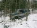 1990 Ford Bronco - This Ford Bronco appears to be from the early 1990s and is stuck in a snowy, wooded area.