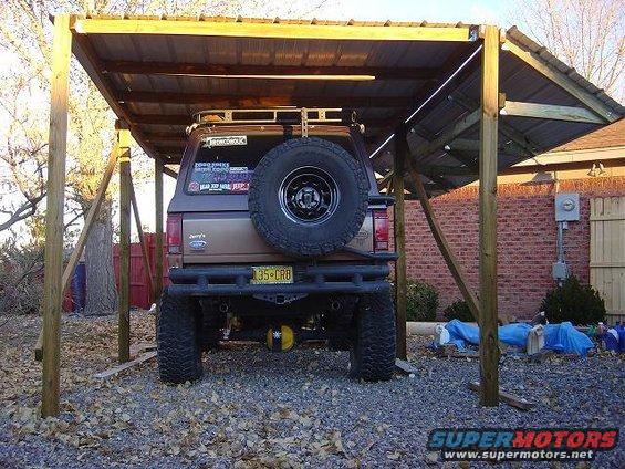 Rear view of a 1986 Ford Bronco II with a spare tire mounted on the back and a yellow license plate
