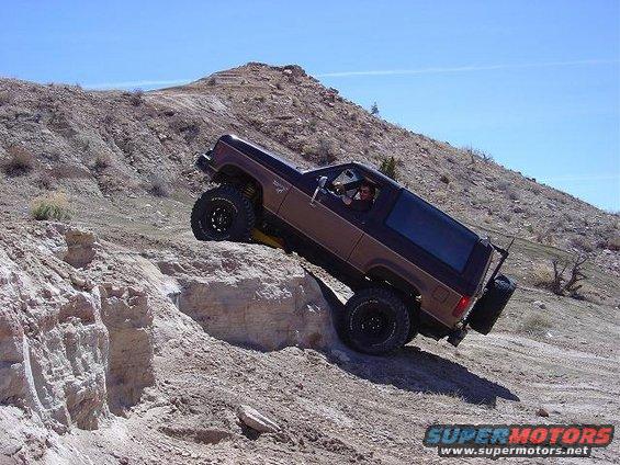 Brown 1986 Ford Bronco II climbing a rocky incline