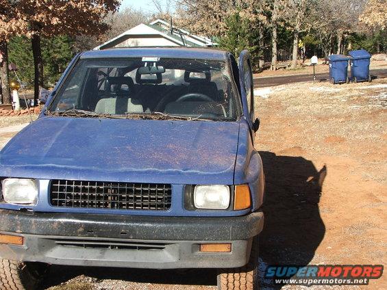 Blue SUV front view, grille and headlights visible