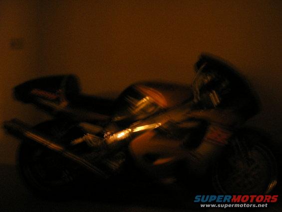 Blurry side view of a motorcycle in low light