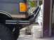 1988 Ford Bronco - Close-up of a dark gray fender and custom tubular bumper with chrome trim, likely from a late 1980s truck or SUV.