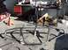 1988 Ford Bronco - A custom metal roll cage is shown on jack stands in a workshop environment.