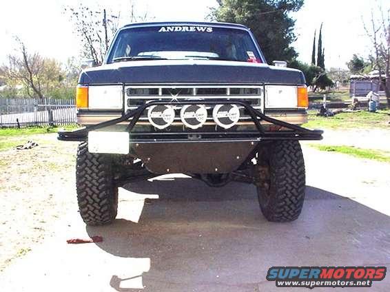 1987 Ford Bronco front end with aftermarket bumper and lights. "ANDREWS" text on windshield