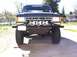 1988 Ford Bronco - Front view of a Ford Bronco with an aftermarket bumper and auxiliary lights. "ANDREWS" is visible on the windshield.