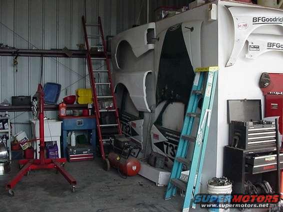 Car body panels and an air compressor in a workshop