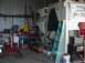 1988 Ford Bronco - A workshop scene with various car parts and equipment, including an air compressor and ladders.
