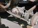 1988 Ford Bronco - Close-up view of the rear axle and suspension components of a vehicle under repair.