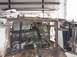 1988 Ford Bronco - The engine bay and front chassis of a vehicle undergoing modification, showing custom fabrication work and stock components.