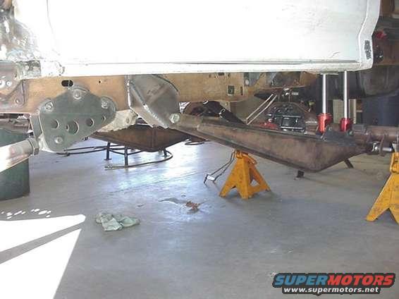 vehicle frame and suspension on jack stands, under repair