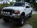 2000 Ford Excursion - This lifted white Ford Excursion features KC auxiliary lights on the front bumper.