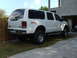 2000 Ford Excursion - Lifted white Ford Excursion SUV with FX4 Off-Road badging is parked in a driveway.