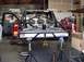 1988 Ford Bronco - A custom truck is shown in a workshop with its bed modified for off-road use.