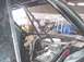 1988 Ford Bronco - The interior of a modified vehicle shows a roll cage and a prominent engine setup.