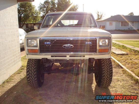 Front view of a lifted Ford Bronco with large tires. Grille has Ford logo