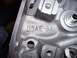 1979 Ford Bronco - A close-up view of a dark metal engine component displaying the casting numbers D5AE-BA.