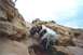 1978 Ford Bronco - Two off-road buggies navigate a challenging rocky incline under a cloudy sky.