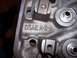 1979 Ford Bronco - This is a close-up view of a cast iron engine cylinder head, showing stamped identification numbers.