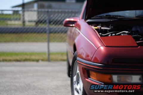 Red 1991 Ford Probe with hood open, seen from the front-right