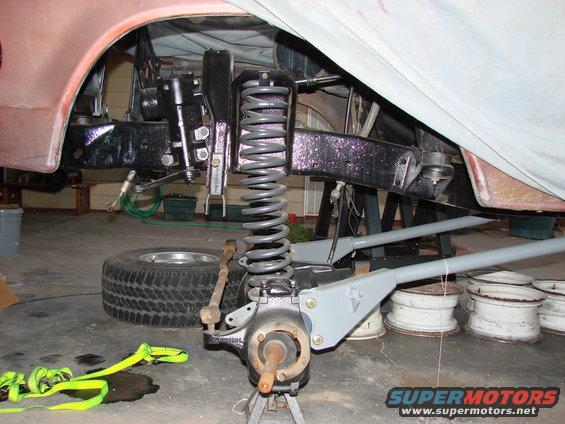 Front suspension assembly with coil spring and brake components