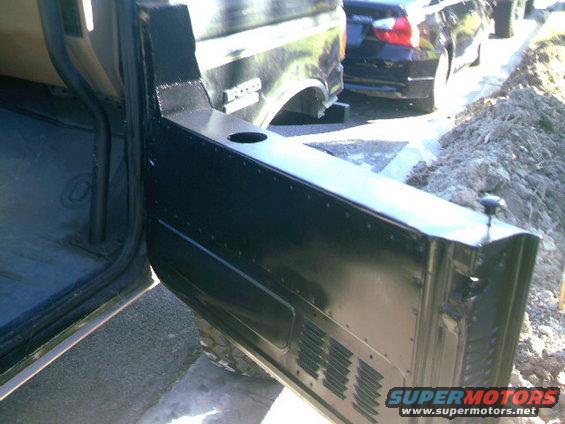Black half door open, showing interior and part of a 1989 Ford Bronco