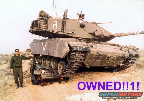 Tank crushing a car, with a soldier standing nearby