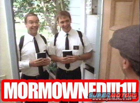 Two men in white shirts and ties stand at a doorway holding books