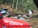 1990 Ford Bronco - Two off-road vehicles are engaged in a recovery operation in a forested, rocky terrain.