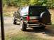 1989 Ford Bronco - This black 1989 Ford Bronco is viewed from the rear, a spare tire mounted on the tailgate.