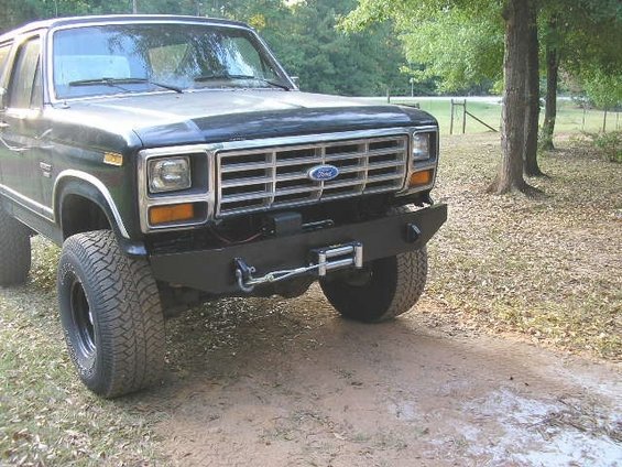Ford Bronco front end with aftermarket bumper and winch. Grille shows Ford logo