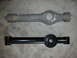 1990 Ford Mustang - A comparison of an old and new suspension control arm, likely for a vehicle's rear axle.