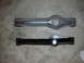 1990 Ford Mustang - Comparison of an old and a newly painted suspension control arm, likely for a vehicle rebuild.