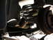 1990 Ford Mustang - Close-up of a vehicle's rear suspension system, focusing on the coil spring and brake drum.