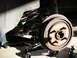 1990 Ford Mustang - Close-up of a vehicle's rear suspension system, showing a brake drum and coil spring.
