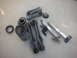 1990 Ford Mustang - Collection of automotive suspension parts, likely for a rear-wheel-drive car, on a concrete surface.