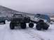 2003 Ford Ranger - Two off-road vehicles, a red pickup and a white Jeep, navigate a snowy terrain during an outing.