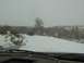 2003 Ford Ranger - A dark SUV navigates a snowy road during a winter day.