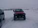 2003 Ford Ranger - Two trucks are parked in a snowy field with a person walking between them.