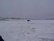 2003 Ford Ranger - A lone dark SUV is visible in the distance, surrounded by a desolate, snow-covered landscape on a cloudy day.