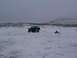 2003 Ford Ranger - Truck pulls a sled with a person and dog across a snow-covered landscape.
