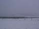 2003 Ford Ranger - A desolate winter scene with a fence line cutting across a snow-covered field and rolling hills in the background.