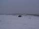 2003 Ford Ranger - A single off-road vehicle sits in a snow-covered landscape under a cloudy sky.