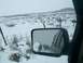 2003 Ford Ranger - Two trucks navigate a snowy landscape, viewed through the side mirror of another vehicle.
