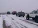 2003 Ford Ranger - Several off-road vehicles navigate a snowy path, with one vehicle in the foreground showing extensive modifications.