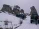 2003 Ford Ranger - Two SUVs navigate a snowy incline with distinctive rock formations in the background.