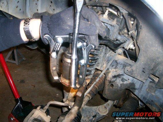 100_0458.jpg Three jaw puller and 36 mm socket pressing out upper ball joint from knuckle/spindle