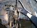 Another shot of three jaw puller and 36 mm socket pressing out upper ball joint.  A small bolt was p...